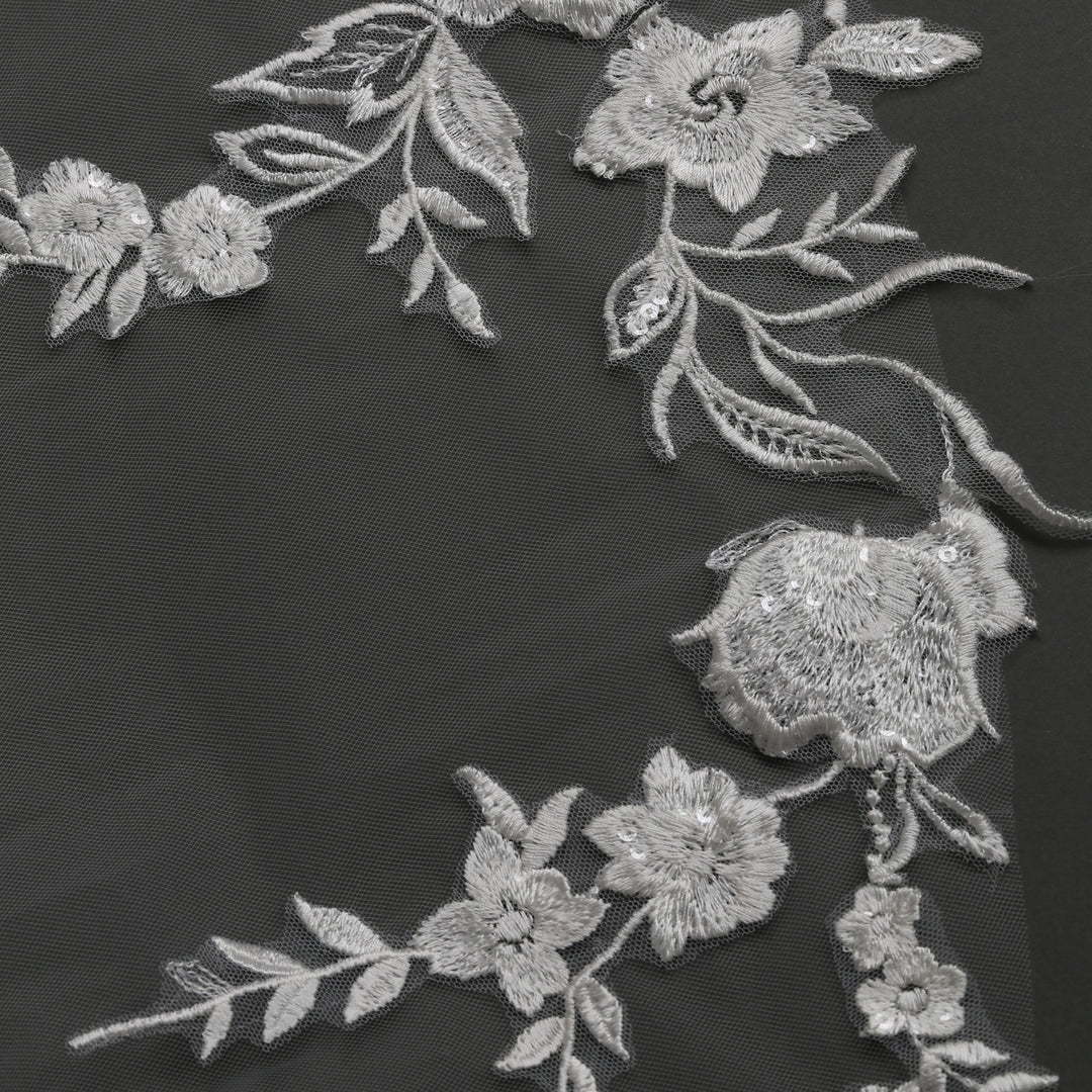 Close-up of FS6277 floral lace edges with rhinestone accents.