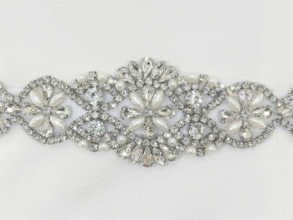 Close-up of S1001 lace embroidery with rhinestones and pearls.