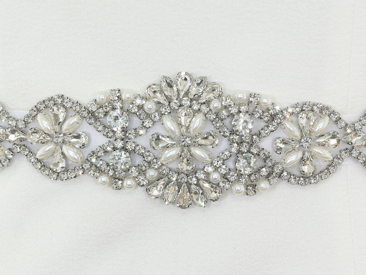 Close-up of S1001 lace embroidery with rhinestones and pearls.
