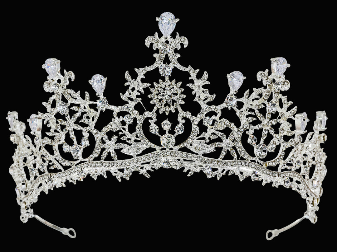 Full-frontal studio shot of a silver-toned tiara featuring pear-cut rhinestones, pave-set crystals, and filigree metalwork.