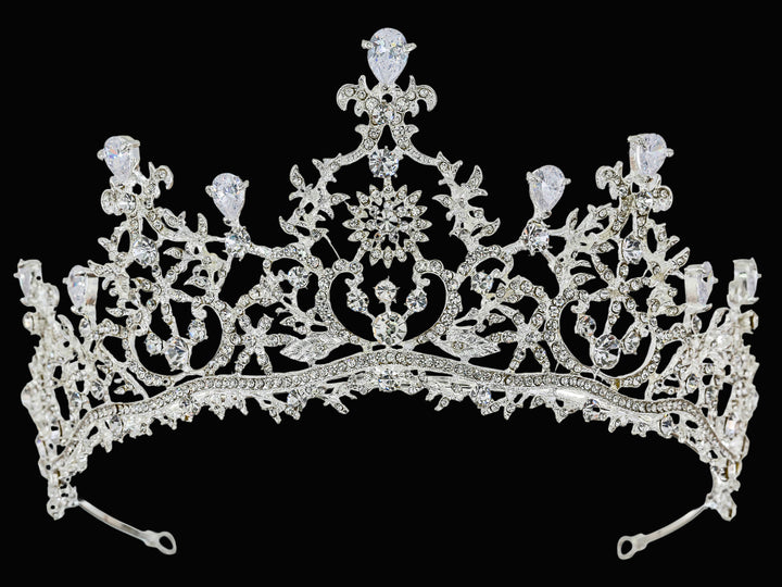 Full-frontal studio shot of a silver-toned tiara featuring pear-cut rhinestones, pave-set crystals, and filigree metalwork.