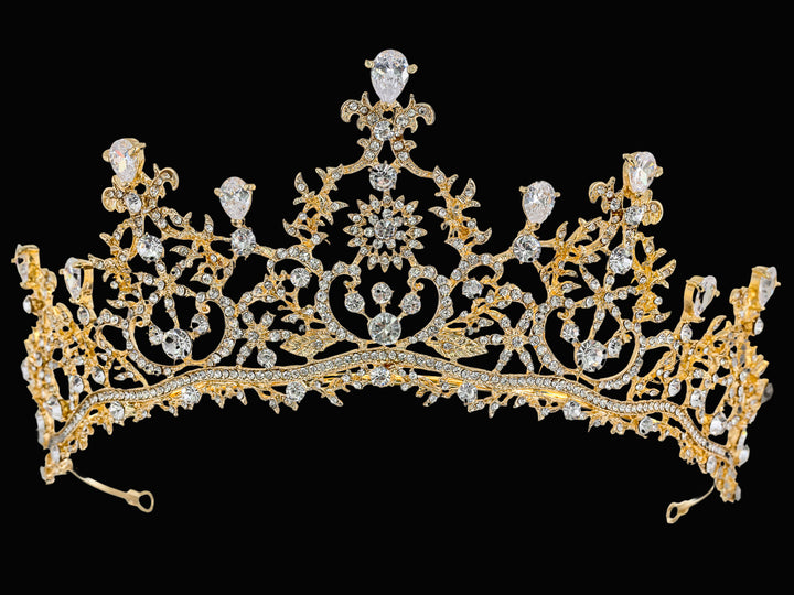 Full front view of a gold-plated crown featuring clear pear-cut, round, and marquise-cut crystals in a floral filigree.